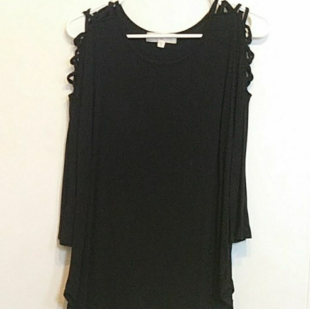 1 Black Top with crossed rips on the shoulders.